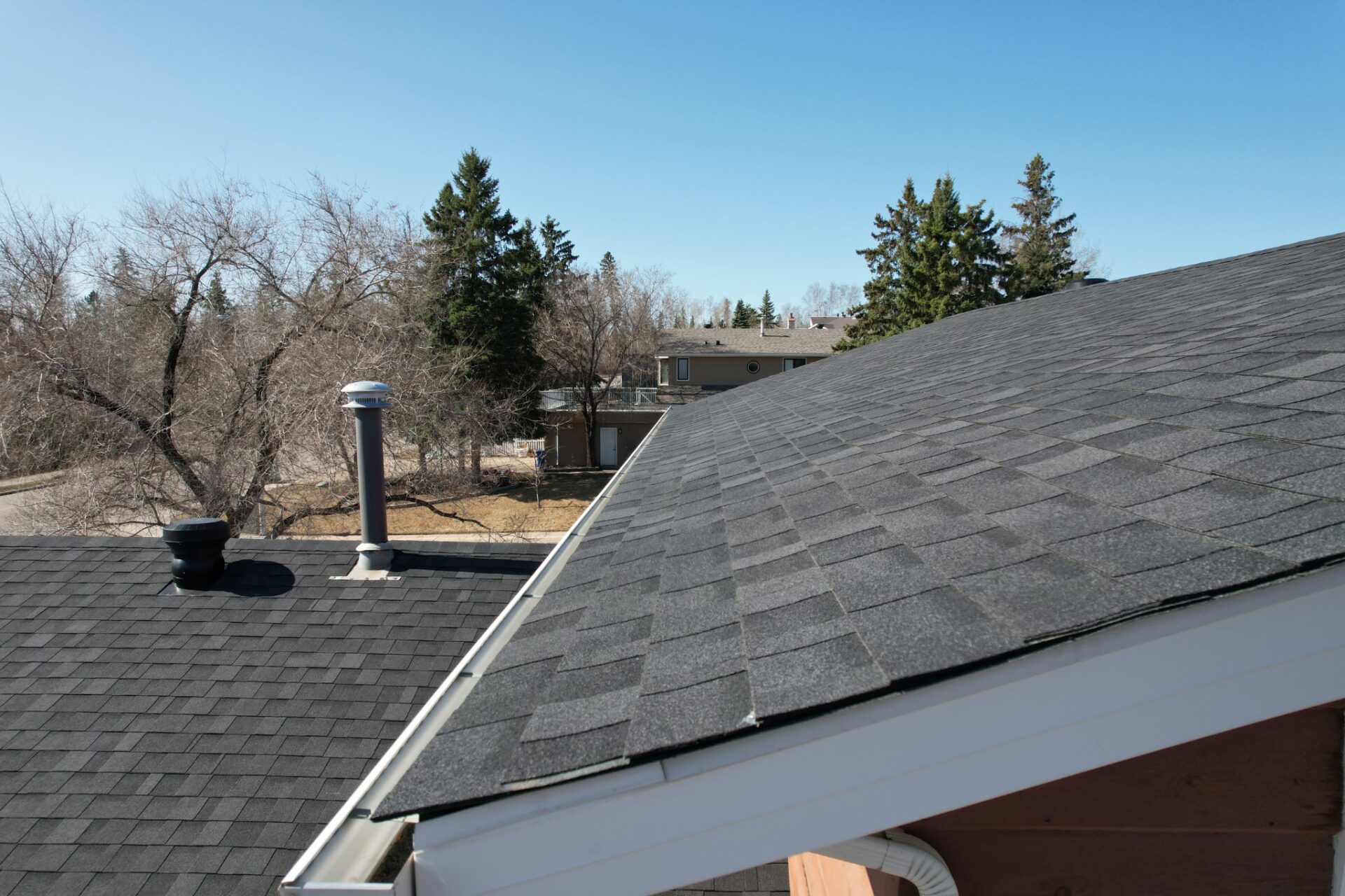 Residential home with a well-maintained roof and landscaped yard